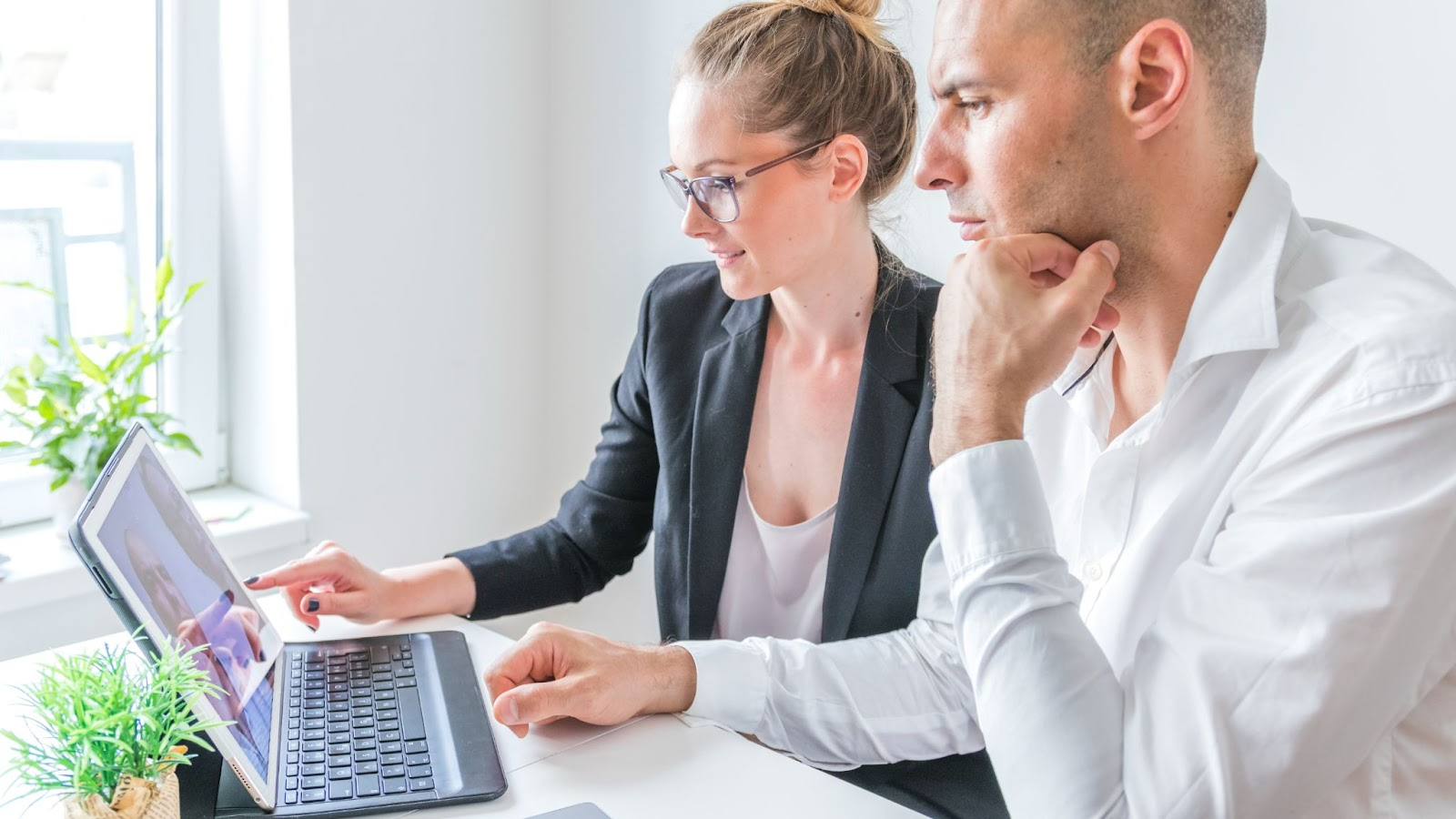 Two_people_looking_at_laptop_professional